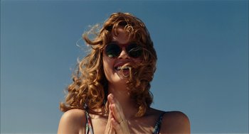 Movie still from “The Master” (2012), directed by Paul Thomas Anderson – A person wearing sunglasses and holding their hands up; Close Up shot, Low angle