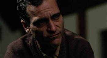 Movie still from “The Master” (2012), directed by Paul Thomas Anderson – A person wearing a sweater; Close Up shot, Over the shoulder angle