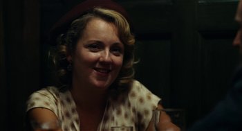 Movie still from “The Master” (2012), directed by Paul Thomas Anderson – A woman wearing a polka dot shirt and a red hat; Close Up shot, Over the shoulder angle