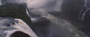 Movie still from “The Mission” (1986), directed by Roland Joffé – A view of a body of water and a waterfall; Extreme Wide shot, High angle