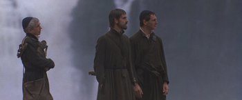 Movie still from “The Mission” (1986), directed by Roland Joffé – A couple of men standing next to each other; Medium shot, Low angle