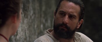 Movie still from “The Mission” (1986), directed by Roland Joffé – A man with a goatee and a beard looking to his left; Close Up shot, Low angle
