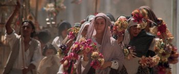 Movie still from “The Mission” (1986), directed by Roland Joffé – A group of women holding bunches of flowers in their hands; Medium shot, Low angle