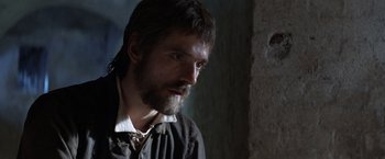 Movie still from “The Mission” (1986), directed by Roland Joffé – A person with a beard; Close Up shot, Over the shoulder angle