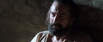 Movie still from “The Mission” (1986), directed by Roland Joffé – A man with long hair and a long beard; Close Up shot, Low angle