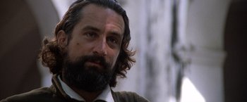 Movie still from “The Mission” (1986), directed by Roland Joffé – A person with long hair and a beard; Close Up shot, Low angle