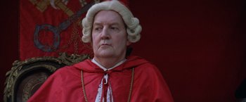 Movie still from “The Mission” (1986), directed by Roland Joffé – A person wearing a wig; Close Up shot, Low angle