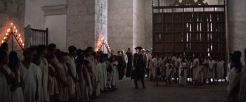 Movie still from “The Mission” (1986), directed by Roland Joffé – A group of people standing in front of a building; Extreme Wide shot, High angle