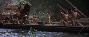 Movie still from “The Mission” (1986), directed by Roland Joffé – A group of people in a boat on a body of water; Wide shot, Low angle