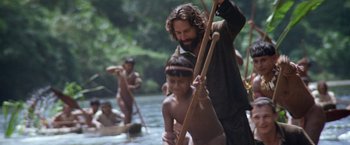 Movie still from “The Mission” (1986), directed by Roland Joffé – A group of people in a body of water; Medium shot, Over the shoulder angle