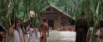 Movie still from “The Mission” (1986), directed by Roland Joffé – A group of people standing in front of a building; Extreme Wide shot, Low angle