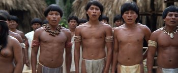 Movie still from “The Mission” (1986), directed by Roland Joffé – A group of young men standing next to each other; Medium shot, Low angle