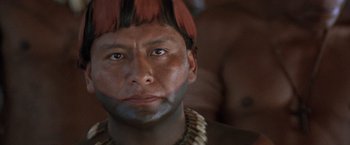 Movie still from “The Mission” (1986), directed by Roland Joffé – A man with a red wig on his head; Close Up shot, Over the shoulder angle