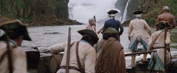 Movie still from “The Mission” (1986), directed by Roland Joffé – A group of people on a boat in the water; Extreme Wide shot, Low angle