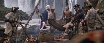 Movie still from “The Mission” (1986), directed by Roland Joffé – A group of people standing around a body of water; Wide shot, High angle