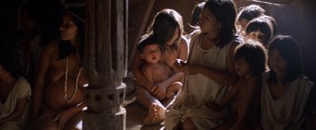 Movie still from “The Mission” (1986), directed by Roland Joffé – A group of people sitting in a room; Medium shot, Low angle