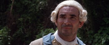 Movie still from “The Mission” (1986), directed by Roland Joffé – A person wearing a wig; Close Up shot, Low angle