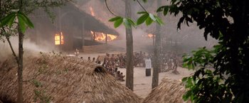 Movie still from “The Mission” (1986), directed by Roland Joffé – A group of people sitting in front of a fire; Extreme Wide shot, High angle