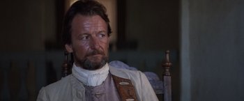 Movie still from “The Mission” (1986), directed by Roland Joffé – A person sitting in a chair; Close Up shot, Over the shoulder angle