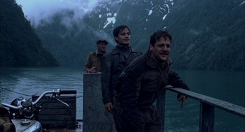 Movie still from “The Motorcycle Diaries” (2004), directed by Walter Salles – A group of men standing next to a body of water; Medium shot, Low angle