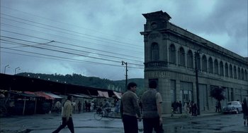 Movie still from “The Motorcycle Diaries” (2004), directed by Walter Salles – A group of people walking on a street near a building; Extreme Wide shot, Low angle