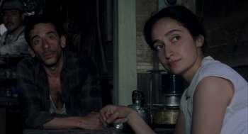 Movie still from “The Motorcycle Diaries” (2004), directed by Walter Salles – A man and a woman sitting at a table in a kitchen; Close Up shot, High angle