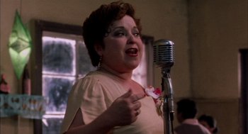 Movie still from “The Motorcycle Diaries” (2004), directed by Walter Salles – An older woman singing into an old microphone; Close Up shot, Low angle