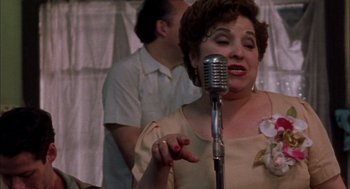 Movie still from “The Motorcycle Diaries” (2004), directed by Walter Salles – An older woman singing into an old fashioned microphone; Close Up shot, Low angle