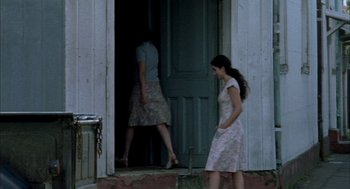 Movie still from “The Motorcycle Diaries” (2004), directed by Walter Salles – Two women are standing in front of a door; Wide shot, Over the shoulder angle
