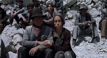 Movie still from “The Motorcycle Diaries” (2004), directed by Walter Salles – A group of people sitting on top of a pile of rocks; Medium shot, Low angle