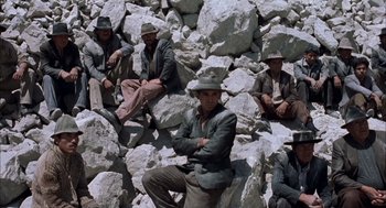 Movie still from “The Motorcycle Diaries” (2004), directed by Walter Salles – A group of men sitting on top of a pile of rocks; Wide shot, High angle