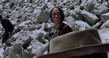 Movie still from “The Motorcycle Diaries” (2004), directed by Walter Salles – A woman standing in front of a pile of rocks; Close Up shot, Low angle