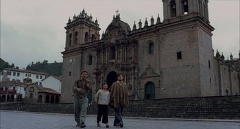 Movie still from “The Motorcycle Diaries” (2004), directed by Walter Salles – Three people are walking in front of a building; Extreme Wide shot, Low angle
