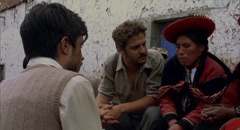 Movie still from “The Motorcycle Diaries” (2004), directed by Walter Salles – A group of people sitting on the ground talking to each other; Medium shot, Over the shoulder angle