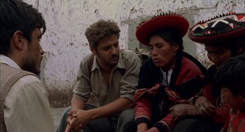 Movie still from “The Motorcycle Diaries” (2004), directed by Walter Salles – A man and a woman sitting next to each other on the ground; Medium shot, High angle