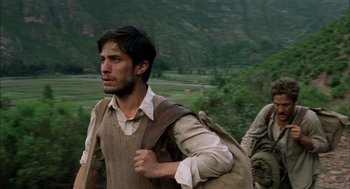 Movie still from “The Motorcycle Diaries” (2004), directed by Walter Salles – A man with a backpack walking in a field; Medium shot, Low angle