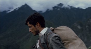 Movie still from “The Motorcycle Diaries” (2004), directed by Walter Salles – A man with a backpack walking in a mountainous area; Close Up shot, Low angle