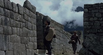 Movie still from “The Motorcycle Diaries” (2004), directed by Walter Salles – Two men are walking up a stone wall; Wide shot, Low angle