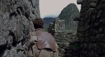 Movie still from “The Motorcycle Diaries” (2004), directed by Walter Salles – A man with a backpack looking out at the mountains; Wide shot, Over the shoulder angle