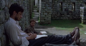 Movie still from “The Motorcycle Diaries” (2004), directed by Walter Salles – Two men sitting on the ground reading books; Wide shot, Low angle