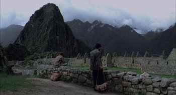 Movie still from “The Motorcycle Diaries” (2004), directed by Walter Salles – Two people are standing on a stone wall; Wide shot, Over the shoulder angle
