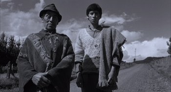 Movie still from “The Motorcycle Diaries” (2004), directed by Walter Salles – A man and a woman standing next to each other on the side of a road; Medium shot, Low angle
