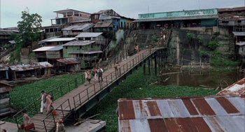 Movie still from “The Motorcycle Diaries” (2004), directed by Walter Salles – People walking across a bridge over a river; Extreme Wide shot, High angle