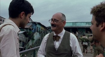 Movie still from “The Motorcycle Diaries” (2004), directed by Walter Salles – An older man wearing a bow tie talking to a young man; Medium shot, Over the shoulder angle