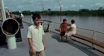Movie still from “The Motorcycle Diaries” (2004), directed by Walter Salles – A man standing on a pier next to a body of water; Wide shot, Over the shoulder angle