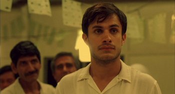 Movie still from “The Motorcycle Diaries” (2004), directed by Walter Salles – A young man in a white shirt looking at the camera; Close Up shot, Over the shoulder angle