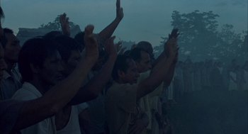 Movie still from “The Motorcycle Diaries” (2004), directed by Walter Salles – A group of people standing in a field with their hands up; Extreme Wide shot, High angle