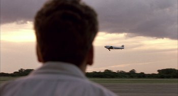 Movie still from “The Motorcycle Diaries” (2004), directed by Walter Salles – A man looking at an airplane flying in the sky; Extreme Wide shot, Low angle