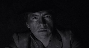 Movie still from “The Motorcycle Diaries” (2004), directed by Walter Salles – A black and white photo of a man in a hat; Close Up shot, Low angle