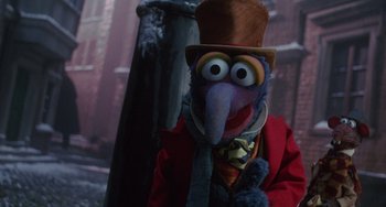 Movie still from “The Muppet Christmas Carol” (1992), directed by Brian Henson – A person wearing a costume and a hat; Close Up shot, Low angle